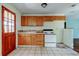 Kitchen with light wood cabinets, white stove and tile flooring at 4479 Newark N St, St Petersburg, FL 33714