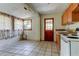 Shows the kitchen with tile floor, wood cabinets, a window, and an exterior door at 4479 Newark N St, St Petersburg, FL 33714