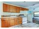 Kitchen featuring light wood cabinets and a white oven at 4479 Newark N St, St Petersburg, FL 33714