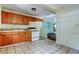 Kitchen with wood cabinets and view into adjacent room at 4479 Newark N St, St Petersburg, FL 33714