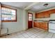 Kitchen with light wood cabinets, tile floors, and access to back door at 4479 Newark N St, St Petersburg, FL 33714