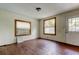 Shows the living room with two windows, wood flooring, and a white door at 4479 Newark N St, St Petersburg, FL 33714