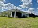 Exterior of the home featuring green grass and lush landscaping at 4510 Big Woods Way, Parrish, FL 34219