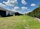 A large backyard with green grass and manicured landscaping at 4510 Big Woods Way, Parrish, FL 34219
