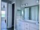 Bathroom with a double vanity, large mirror, and ample cabinet space at 4510 Big Woods Way, Parrish, FL 34219