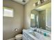 Bathroom features a vanity with a marble countertop, a large mirror, and a glass-enclosed shower at 4510 Big Woods Way, Parrish, FL 34219