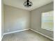 This bedroom offers a neutral color palette, fan, and bright window view at 4510 Big Woods Way, Parrish, FL 34219