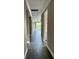 Inviting hallway with sleek flooring leading to a bright living area with a wall of windows at 4510 Big Woods Way, Parrish, FL 34219