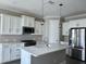 Modern kitchen with white cabinets, stainless steel appliances, and a center island at 4510 Big Woods Way, Parrish, FL 34219