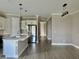 Open-concept kitchen with stainless steel appliances, island, and modern pendant lighting at 4510 Big Woods Way, Parrish, FL 34219
