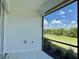Screened lanai overlooking a lush green lawn and a clear blue sky, perfect for outdoor relaxation at 4510 Big Woods Way, Parrish, FL 34219