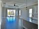 Open living space with a ceiling fan, large windows and light colored walls at 4510 Big Woods Way, Parrish, FL 34219