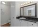 Bathroom with white cabinets, decorative hardware, and granite countertop at 501 Knights Run Ave # 1209, Tampa, FL 33602
