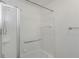 Bathroom features a shower and tub combination with white tile surround and glass doors at 501 Knights Run Ave # 1209, Tampa, FL 33602