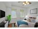 Stylishly furnished bedroom with two large bright windows, a TV and stylish furniture at 501 Knights Run Ave # 1209, Tampa, FL 33602