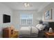 This bedroom has neutral walls and a large window with a ceiling fan and a television at 501 Knights Run Ave # 1209, Tampa, FL 33602
