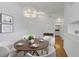 Bright dining room features a modern light fixture, round wood table with seating for four, and wood-look flooring at 501 Knights Run Ave # 1209, Tampa, FL 33602