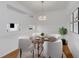 Dining room featuring a round table with seating for four, neutral paint, wood floors, and stylish light fixture at 501 Knights Run Ave # 1209, Tampa, FL 33602