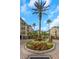 Welcoming entrance featuring lush landscaping, a fountain, and a gated community at 501 Knights Run Ave # 1209, Tampa, FL 33602