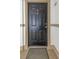 Traditional black front door with classic hardware and decorative molding, enhancing curb appeal at 501 Knights Run Ave # 1209, Tampa, FL 33602