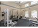 Brightly lit gym with large windows featuring a variety of weight training machines and cardio equipment, well-equipped at 501 Knights Run Ave # 1209, Tampa, FL 33602