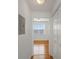 Hallway with hardwood flooring leading to bedroom with ceiling fan and bright window at 501 Knights Run Ave # 1209, Tampa, FL 33602