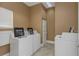 Well-lit laundry room with multiple washers and dryers, community washers and dryers for doing laundry with ease at 501 Knights Run Ave # 1209, Tampa, FL 33602