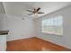Bright living room with beautiful wood floors and ceiling fan with light fixture at 501 Knights Run Ave # 1209, Tampa, FL 33602