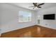 Bright living room featuring wood floors, ceiling fan, and sliding glass doors to the outside at 501 Knights Run Ave # 1209, Tampa, FL 33602