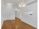 Bright living room with hardwood floors and a view into the kitchen through an opening in the wall at 501 Knights Run Ave # 1209, Tampa, FL 33602