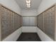 Hallway view of the mailboxes with an overhead light and a dark tile floor with fresh white walls and wood trim at 501 Knights Run Ave # 1209, Tampa, FL 33602