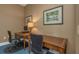 An office room with 2 desks, 2 office chairs, and 2 decorative paintings on the wall at 501 Knights Run Ave # 1209, Tampa, FL 33602