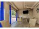 Outdoor patio area with a TV, tables, and chairs for relaxing with beautiful blue curtains to keep the sun out at 501 Knights Run Ave # 1209, Tampa, FL 33602