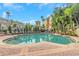 Beautiful community swimming pool with lounge chairs and tropical landscaping at 501 Knights Run Ave # 1209, Tampa, FL 33602