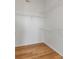 Large walk-in closet featuring hardwood floors and ample shelving at 501 Knights Run Ave # 1209, Tampa, FL 33602