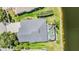 An aerial view shows the home and pool and scenic backyard near the lake at 5141 Riva Ridge Dr, Wesley Chapel, FL 33544