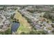 An aerial view displays the property on a golf course with a scenic pond at 5141 Riva Ridge Dr, Wesley Chapel, FL 33544