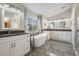 Elegant bathroom featuring double sinks, an oval tub with a modern faucet, and gray marble flooring at 5141 Riva Ridge Dr, Wesley Chapel, FL 33544