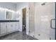 Bright, modern bathroom featuring a glass-enclosed shower, white vanity, and stylish fixtures at 5141 Riva Ridge Dr, Wesley Chapel, FL 33544