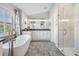 Bright bathroom with double sinks, an oval soaking tub, a glass shower, and modern finishes at 5141 Riva Ridge Dr, Wesley Chapel, FL 33544