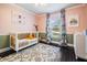 Bedroom with pink walls, a white crib, wood floors, and floral curtains at 5141 Riva Ridge Dr, Wesley Chapel, FL 33544