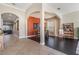 Open dining room with wood floors, arched doorway and terra cotta colored accent wall at 5141 Riva Ridge Dr, Wesley Chapel, FL 33544