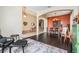 Inviting dining room with dark wood floors and terra cotta colored accent wall at 5141 Riva Ridge Dr, Wesley Chapel, FL 33544