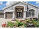 Charming home exterior with meticulously landscaped front yard and a two car garage at 5141 Riva Ridge Dr, Wesley Chapel, FL 33544