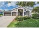 Charming one story home with a three car garage and beautiful landscaping at 5141 Riva Ridge Dr, Wesley Chapel, FL 33544