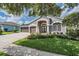 Beautiful one story home with a three car garage, mature trees and green grass at 5141 Riva Ridge Dr, Wesley Chapel, FL 33544