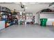 Well-organized garage with ample storage, tools, and epoxy flooring at 5141 Riva Ridge Dr, Wesley Chapel, FL 33544