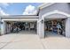 Three car garage with epoxy flooring, storage shelves and tools at 5141 Riva Ridge Dr, Wesley Chapel, FL 33544
