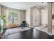 Open concept living room with hardwood floors, large windows and front door access at 5141 Riva Ridge Dr, Wesley Chapel, FL 33544