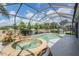 Inviting in-ground pool and spa with screened enclosure and lush landscaping at 5141 Riva Ridge Dr, Wesley Chapel, FL 33544